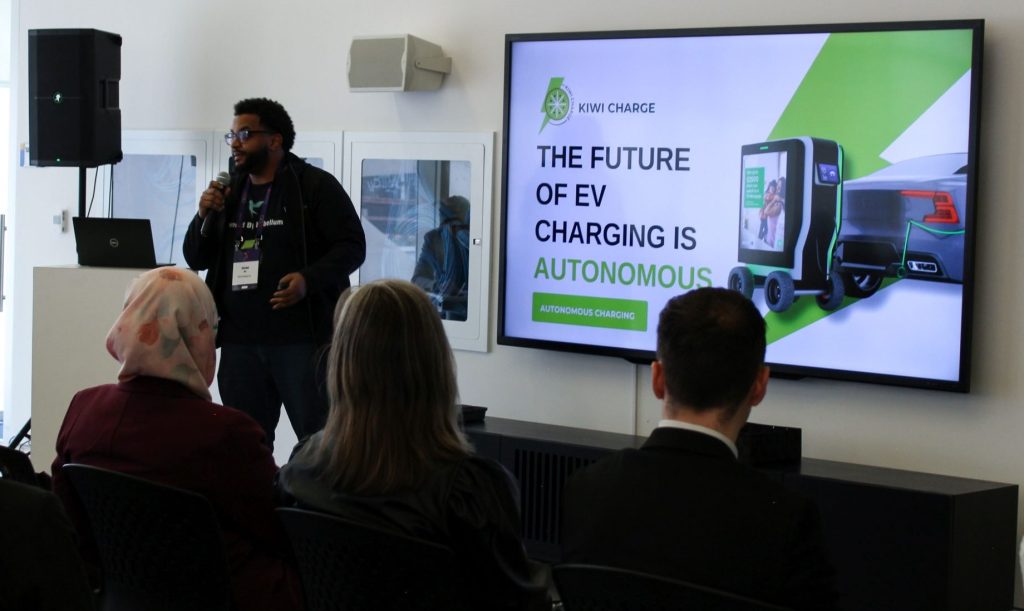 Kiwi Charge Robotic Electric Vehicle Charger Takes Top Prize in Student Pitch Competition at TMU 3 Abdel Ali presenting about Kiwi Charge