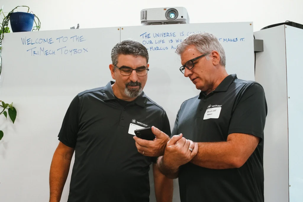 TriMech employees collaborating on a project